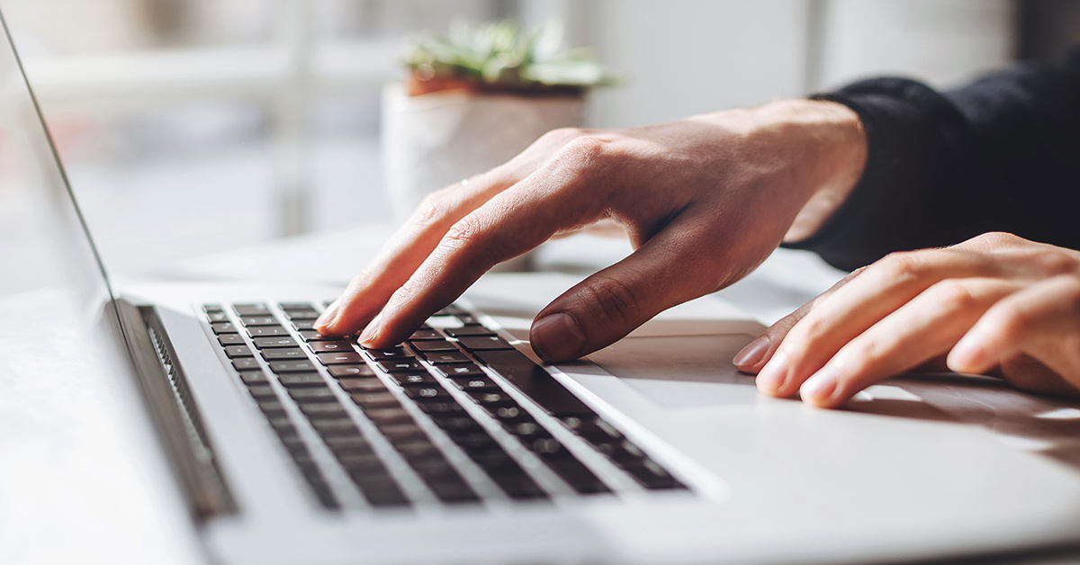 Person typing on a Mac