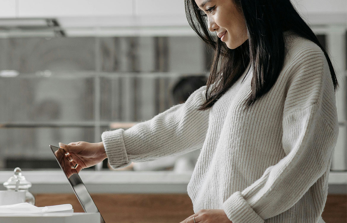Woman looking at her MacBook