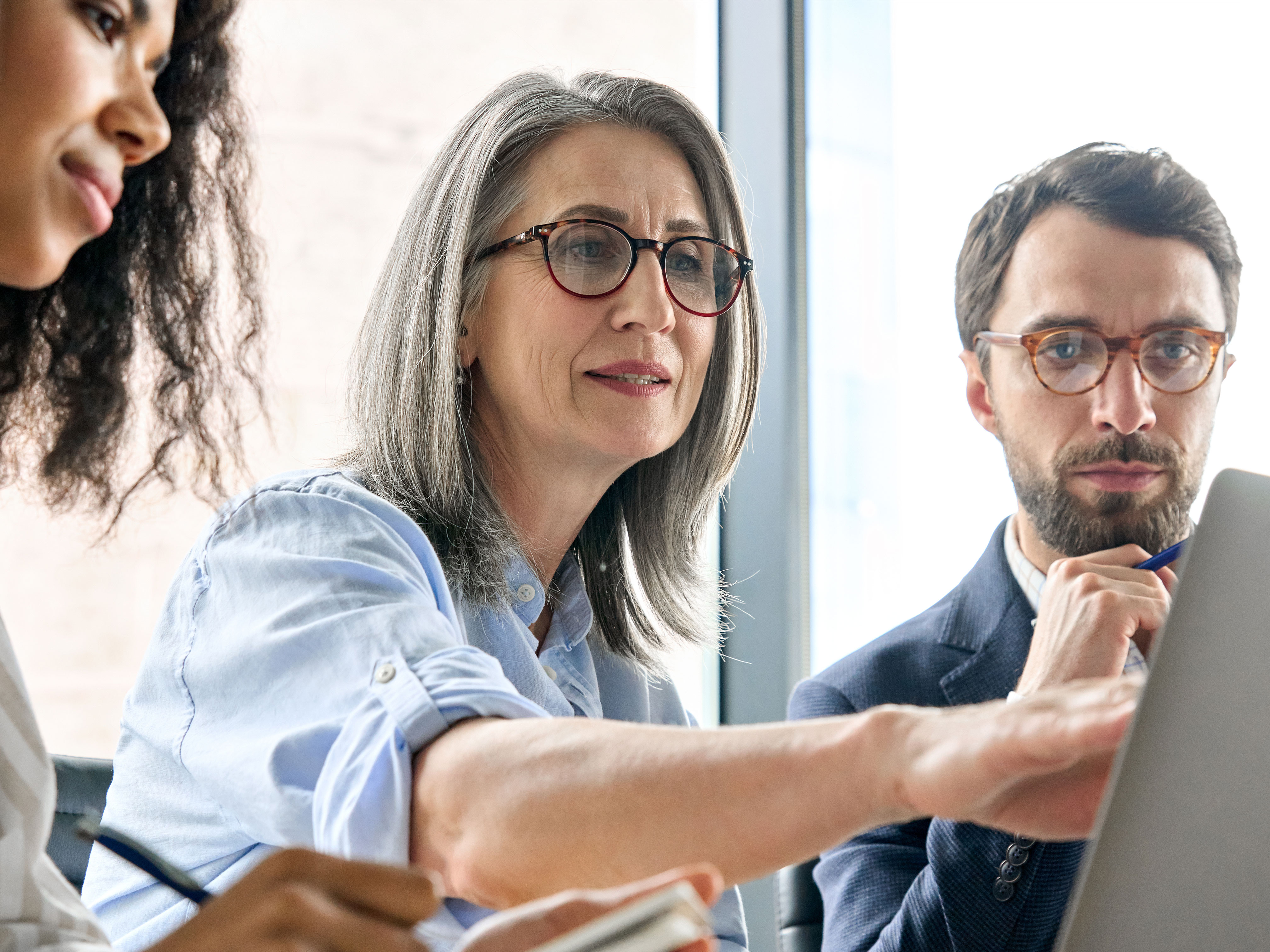 A small group of people using Jamf on a MacBook