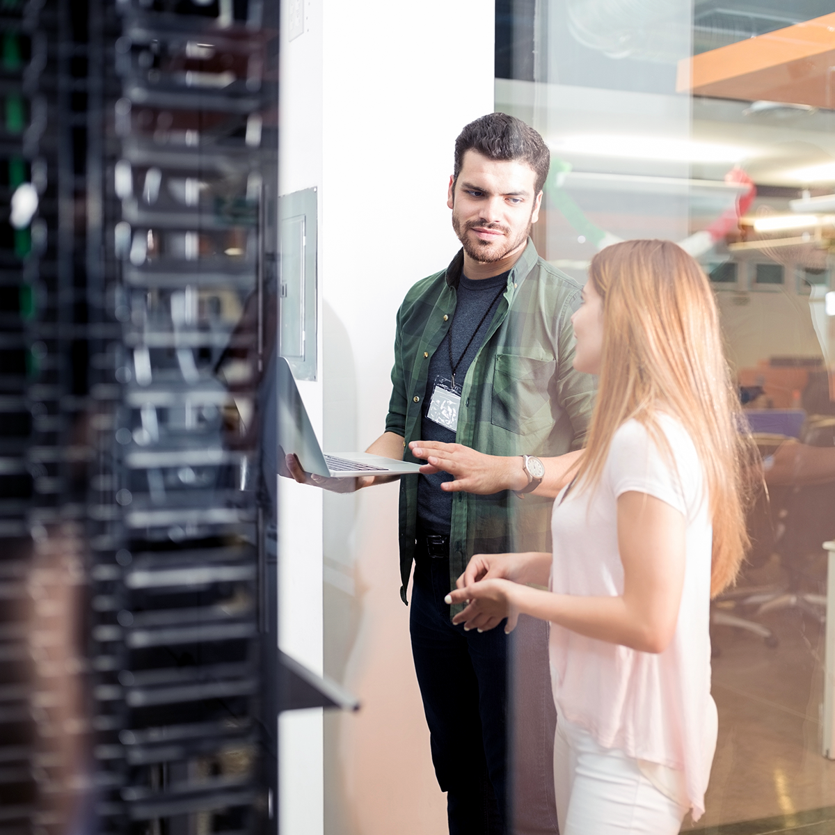 Colleagues standing in front of a large server room