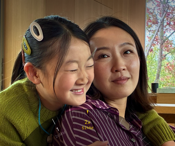 2x Telephoto feature in use, zooming in on mountain covered with trees and vegetation